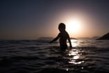 a child wading in the water