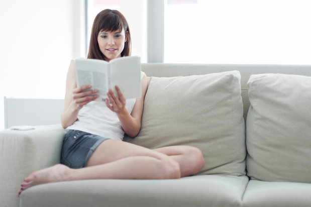 woman reading on a couch