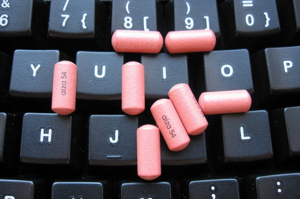 pink concerta pills scattered on the keyboard
