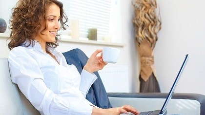 Woman sipping coffee and working.