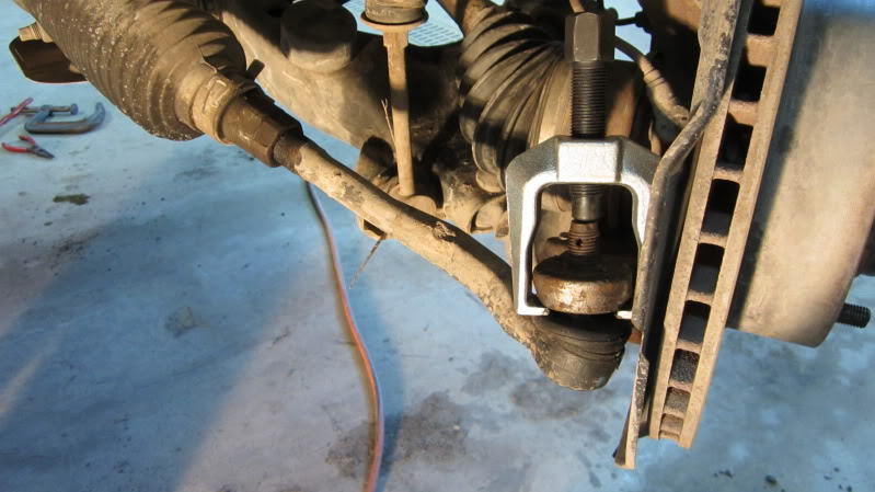 Use the tie rod puller to separate the tie rod from the steering knuckle