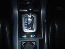 Shift console lights with blue up and down indicators.