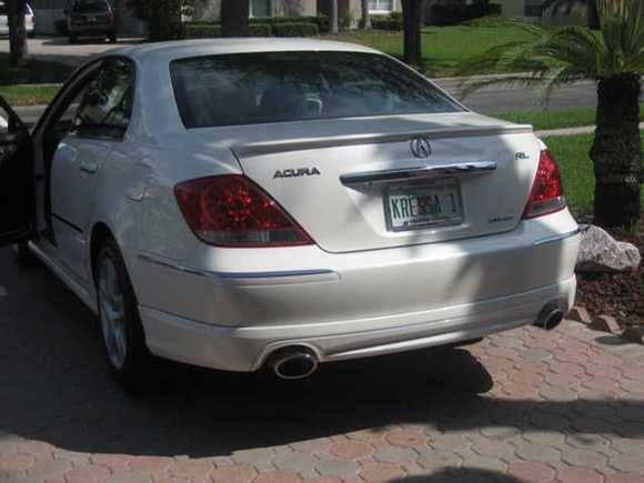 Rear Quarter - Extended exhaust tips with rear spoiler