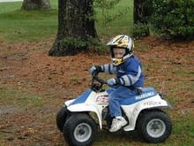 ... but that doesn't stop him from riding.  Tough little kid that really loves riding his ATV.                                                                                                          