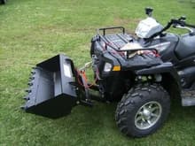 Swisher ATV Bucket just installed.  Notice the mount on the ATV is actually behind the Tire line, the lower frame is short.  Glacier2 plow mount is on