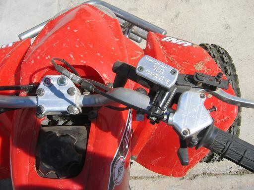 Aluminum master cylinder cover, throttle cover and handle bar mount on the Jetmoto 250.