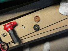 A new piston leather on the top of the old damaged one.  Note the heat gun and pex fastener that will finish the hose assembly.