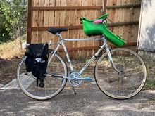 Lower end Peugeot built into baby hauler. Maybe a UO-8? Outfitted with contemporary derailleurs, a 3x crank, and some Kenda XC tires for some dirt trails near our house. I probably ride this one most often. I actually like this frame a ton and will do something else with it once the kid outgrows the stem mounted seat.