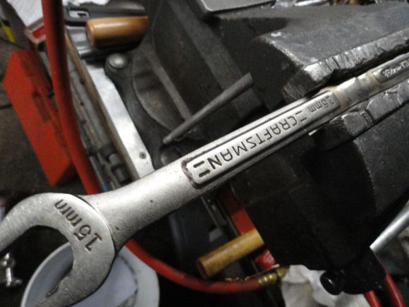 My junkyard pedal wrench three wrenches welded together to get the needed leverage sometimes needed to remove the pedals.  Locked into the vise so I can use the flats of the spindle to break the cone nuts free.