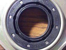 Close up of new axle bearing seal with identification markings.
