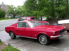My 1968 Mustang. 289, AT. One family car. The paint looks better than it is because of the rain. My old '92 B Blazer is behind it.
