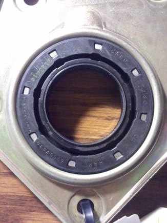 Close up of new axle bearing seal with identification markings.