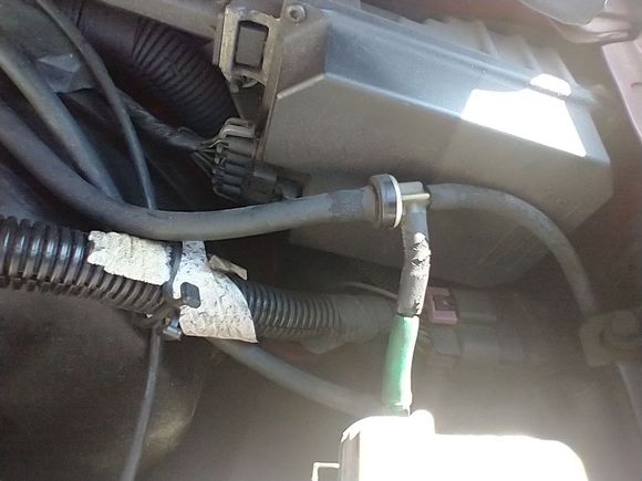 Black hose to the left of this valve goes across engine to AIR system.  Green hose is vacuum source.