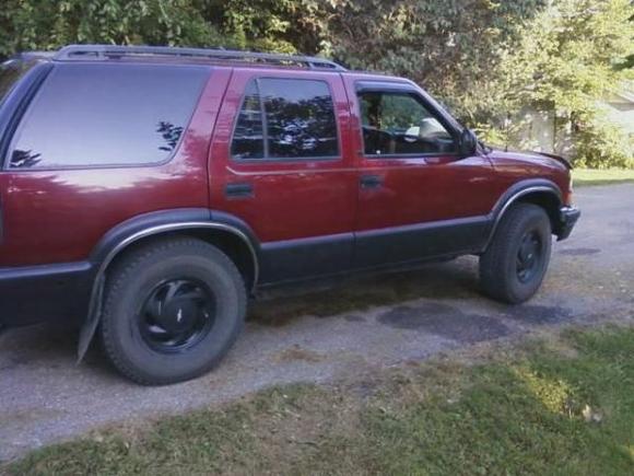 black rocker panels and front and rear bumpers along with black rims.