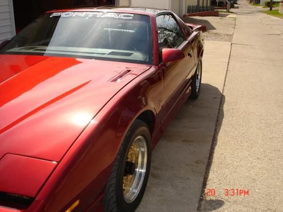 Side view of car that was repainted with red mettallic flake.