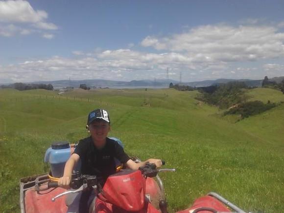My son on the quad how to do some weed control (that's what we told mum) :)