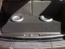 10 inch Rockford Fosgate p3s with a custom enclosed box behind the third row of seats.