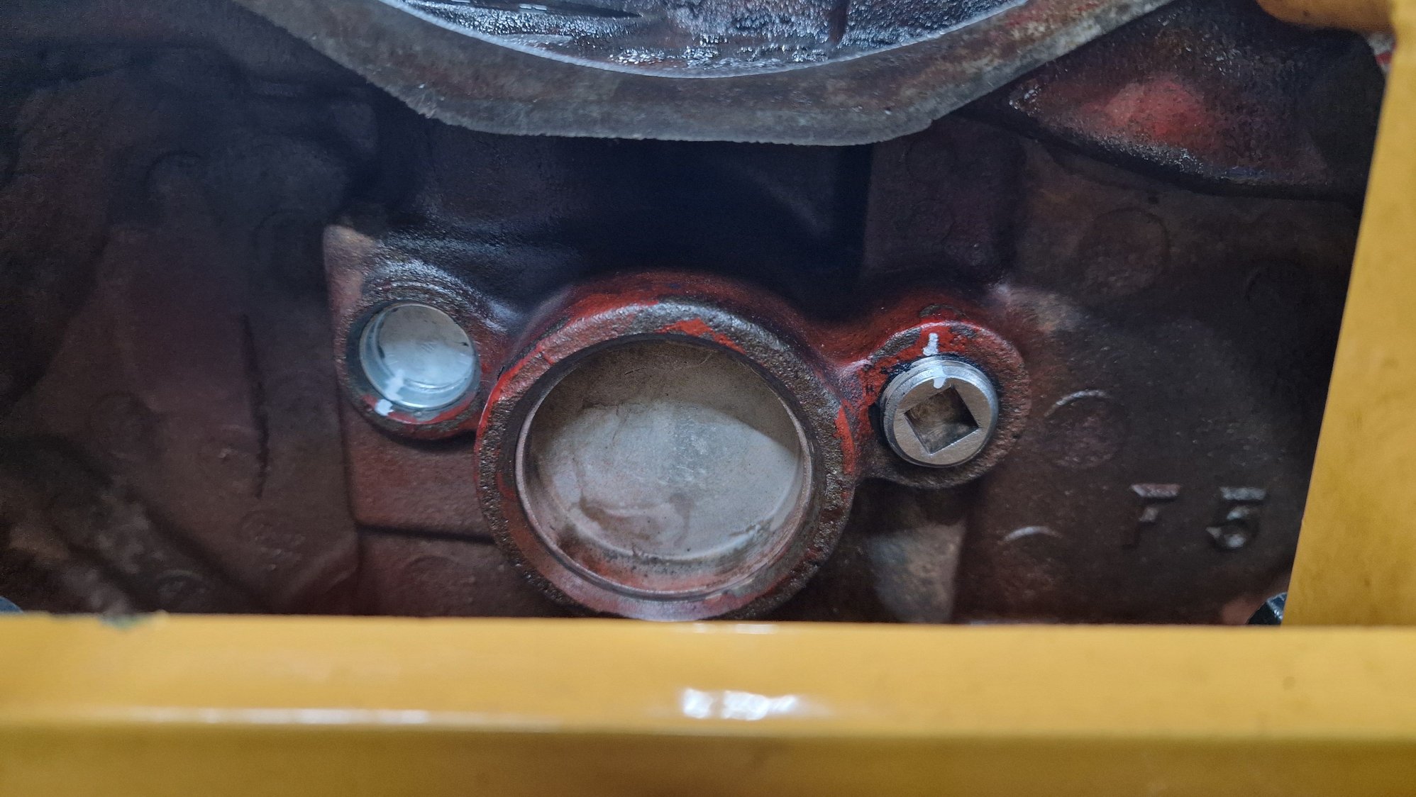 The plug is behind the sheet metal plug on the left