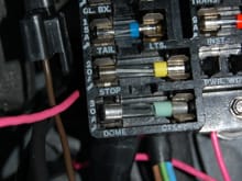 In the lower right corner of this shot, you can see where the pink ignition wire connects to the filter capacitor that is mounted inside on the firewall. This then goes out through the large firewall grommet to the UHV harness