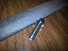 You can see the chamfer around the tip of the bolt.  This was the key to getting it to thread into the damaged hole.