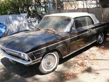 Black 1962 F-85 Deluxe Series Cutlass Convertible. Auto trans, stick on the floor, power windows, new engine, newish white top ('08), dark red two-tone interior. Runs