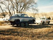 Dad's 55 Desoto being towed from the farm pasture where he found it frame deep in the dirt. Around 1990 in S.D.