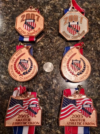 AAU Jr. Track Nationals 2005 - 2007 medals.  The medals were for the High Jump and Pentathlon each year.  The copper colored medals were for 4th - 10th place finishes.  The bronze medal in the upper right was a 3rd place in the Pentathlon in 2007.  Generally there were 35 - 40 competitors form across the country who had placed in the Top 3 of their respective Regions.
