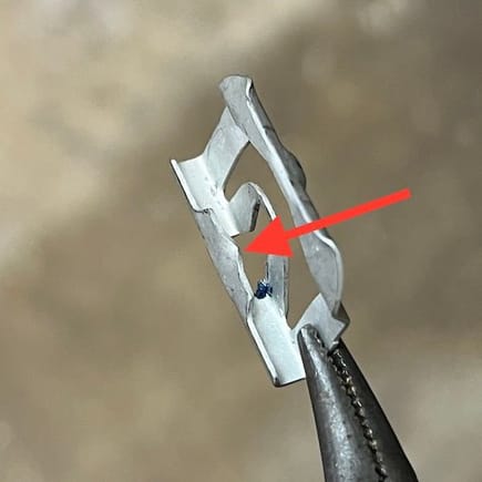 The red arrow shows the tab that doesn't hold the clip tightly.