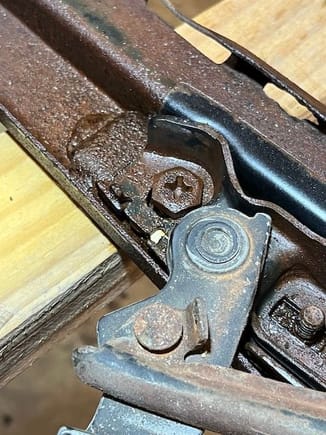 This is the troublesome bolt holding the latches and the header bow.  I sprayed a liberal amount of PB Blaster but could not break it loose.