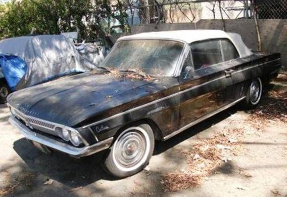 Black 1962 F-85 Deluxe Series Cutlass Convertible. Auto trans, stick on the floor, power windows, new engine, newish white top ('08), dark red two-tone interior. Runs