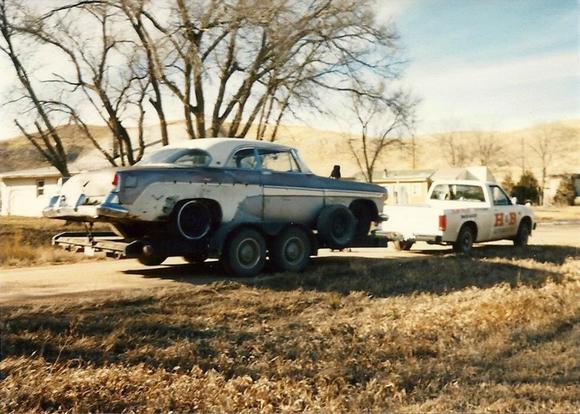 Dad's 55 Desoto being towed from the farm pasture where he found it frame deep in the dirt. Around 1990 in S.D.