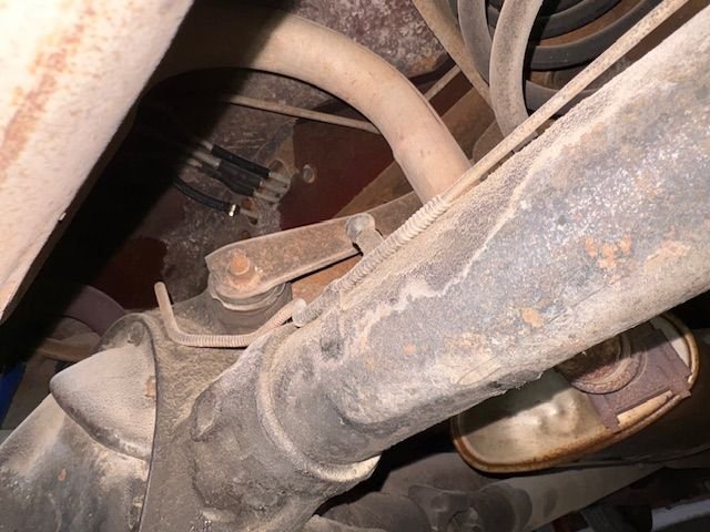 Below in same area.  Look for the fuel vapor lines that are routed through the smaller holes