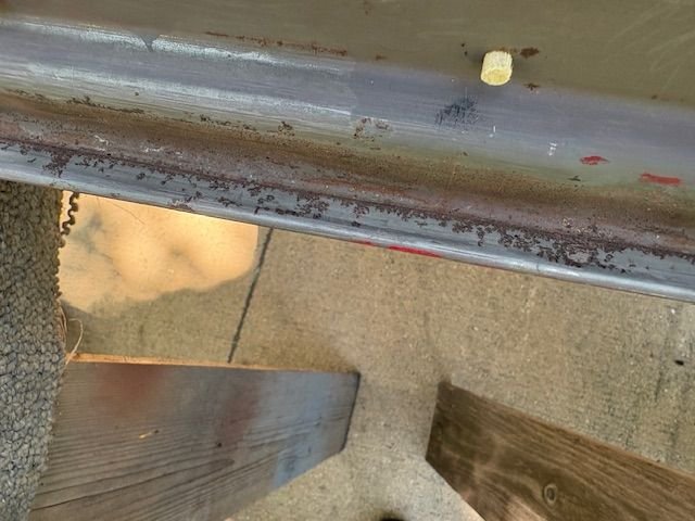 Door bottom seam.  Rust there as well. Perfect for a blaster to knock out.