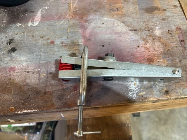 I found that I needed to compress the entire spring to get it in place.  Taking the tool jaws and inserting them into the first coil from the end was not enough.  And the tool didn’t like compressing the entire spring.  It bent the tool, so C clamp to the rescue.