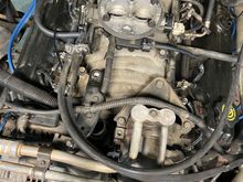 The black bracket that is connected to the alternator and has a black grounding wire attached to it which runs to alternator is the one in question. 