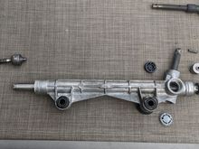 Unstake and unscrew the the driver side inner tie rod. 