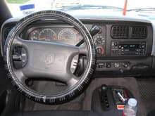 Driver dash view.  Bought steering wheel cover from walmart to protect leather on wheel.  Apparently my hands are a little acidic and over time, it soften the leather where it started melting off the wheel.  Luckily my warranty was still in effect and they replaced the wheel.  Then the steering cover was bought immediately afterwared to prevent a repeat event.  Notice the dashmat.  If any of you have cooling problems in your cabin, I garuantee you that the dashmat will help cool down the temp in your cabin by more than 30%.  I set the fan speed to second from lowest setting to maintain cold temp during DFW's blistering summer temps.