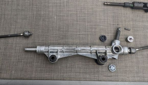 Unstake and unscrew the the driver side inner tie rod. 