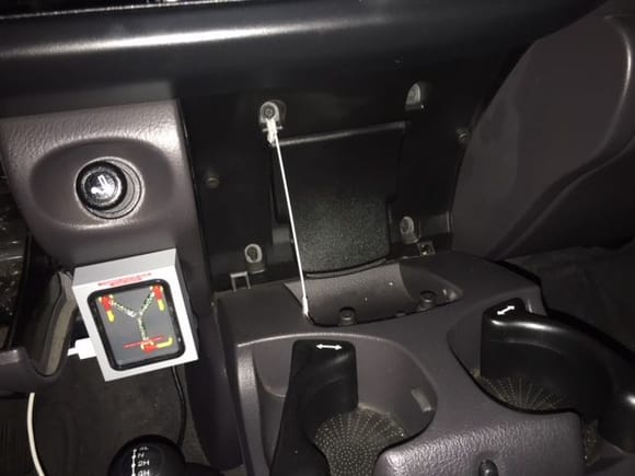 Yes that is a flux capacitor that doubles as a USB charger. (my kid put that in there, it is his truck) The single metal rope hanger is how I fixed the cupholder. (trying to get 2 the same length proved to be difficult and not necessary) 