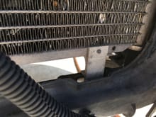 Some debris getting stuck in front of condenser. This condenser will "hook" onto the mounting points at the bottom of the radiator
