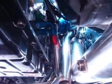 Picture of underside of the car showing Down Pipe, Wastegate Atmospheric Dump, and Trans Fluid Lines. The lines have been relocated since this picture was taken to move them further away from exhaust system.