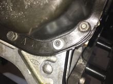 Stripped threads are on the hole with the bright colored washer.