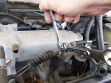 Here I was loosening the throttle cable and cruise control cable from the bracket.