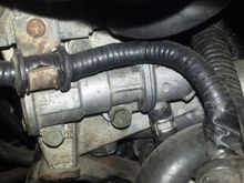 IACV Idle Air Control Valve.  Can be serviced / adjusted.