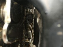 Tension spring for hood cable.