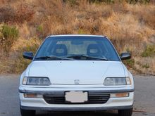 blemished passenger side bumper, small dent/depression in front hood near logo