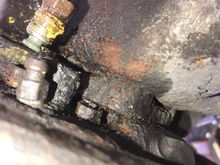 It’s the bolt on the right of the hanging brake line