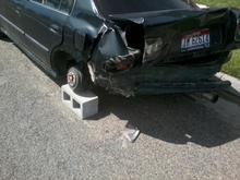 Totaled with wheel removed, on a cinder block