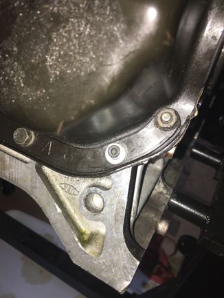 Stripped threads are on the hole with the bright colored washer.