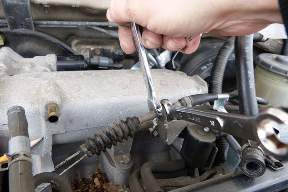 Here I was loosening the throttle cable and cruise control cable from the bracket.